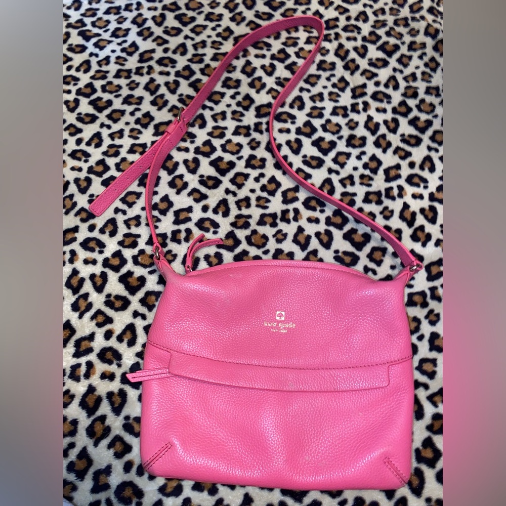 Adorable Pink Kate Spade Cross body, does have a hole in the front zipper part